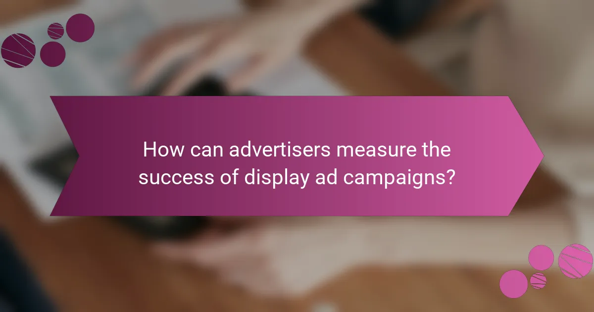 How can advertisers measure the success of display ad campaigns?